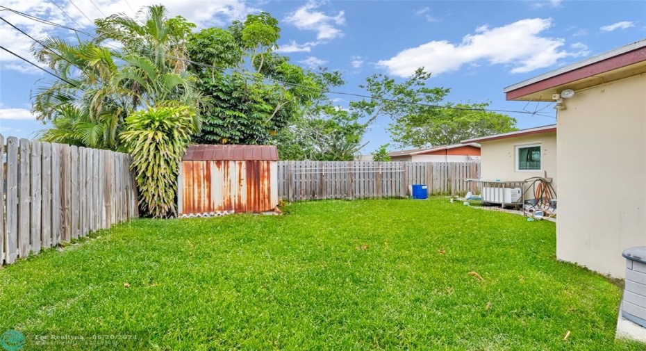 Large and spacious backyard is the perfect space for pets and play sets