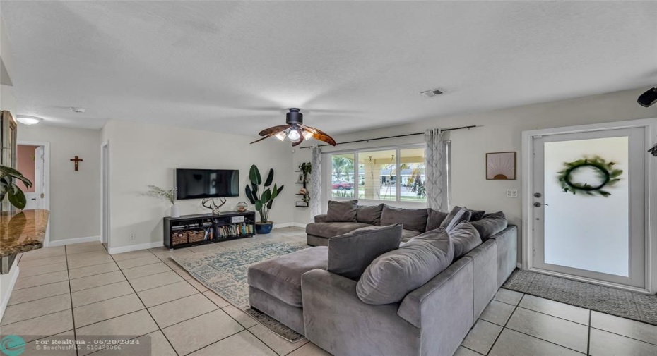 Living Room with an abundance of natural light and tile flooring