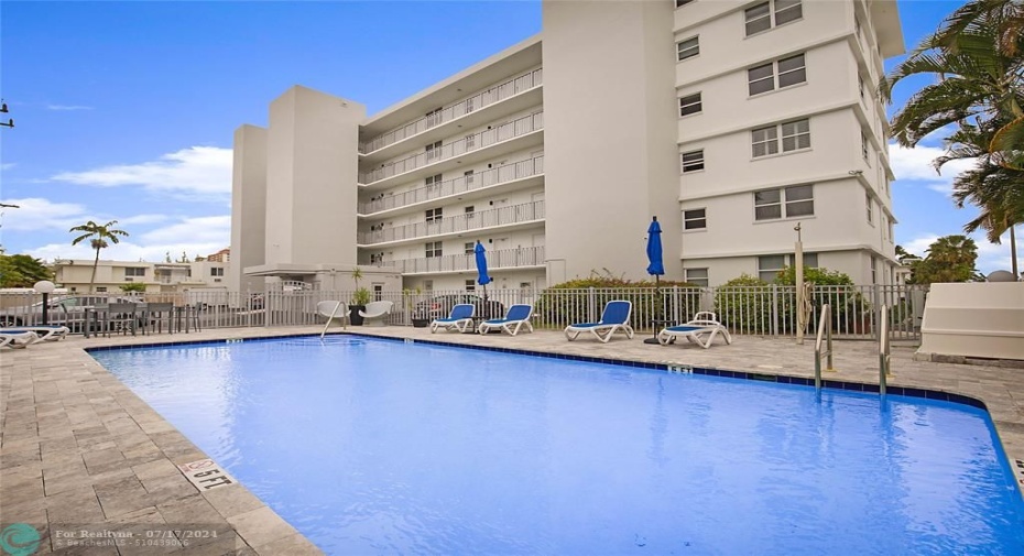 Heated pool just steps from front door of unit.