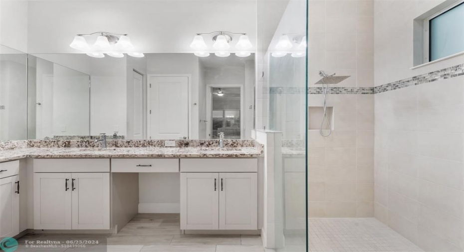 Double Sinks with Vanity and Private Toilet and Linen Closet