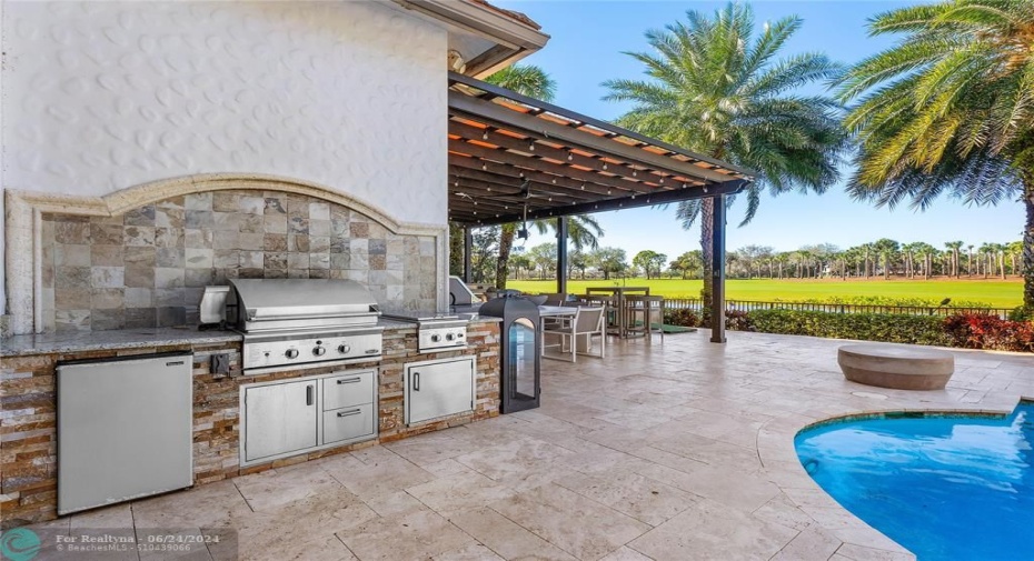 Outdoor kitchen off of pool! features two grills, cooktop and refrigerator