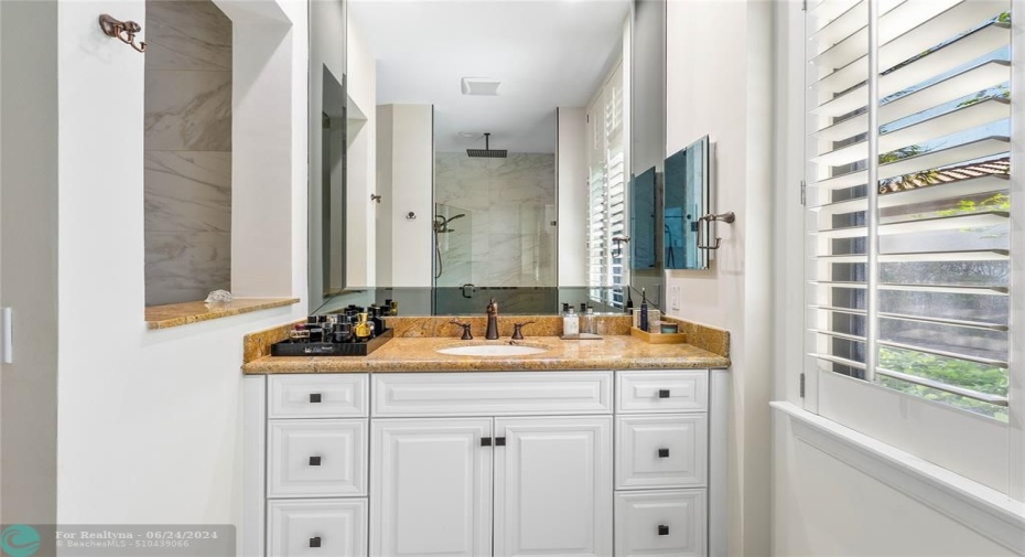 Master bathroom features separate vanities jetted tub, a separate updated shower