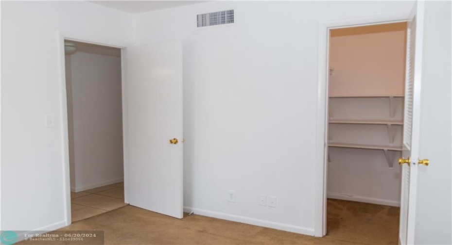 second bedroom with a walk-in closet-carpet is replaced with new tile flooring