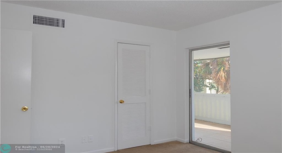 second bedroom with acess to the balcony. carpet out, brand new plank tile flooring in!