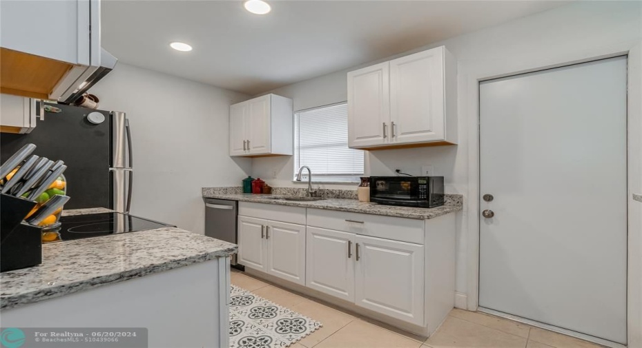 UNIT A(E) - Kitchen with granite countertop & stainless steel appliances