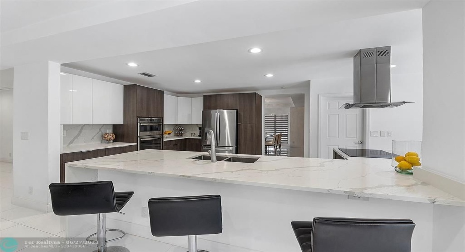 Large breakfast bar/eating area with gorgeous quartz counters with waterfall effect