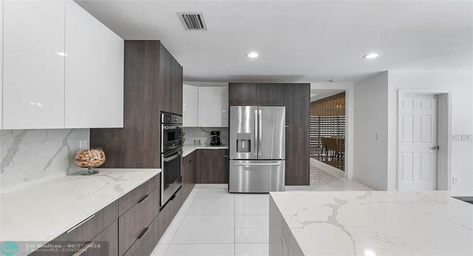 Chef's kitchen with wall oven and microwave, stainless steel appliances