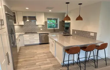 All new kitchen with 2 sink locations, double ovens, bar with wine refrigerator