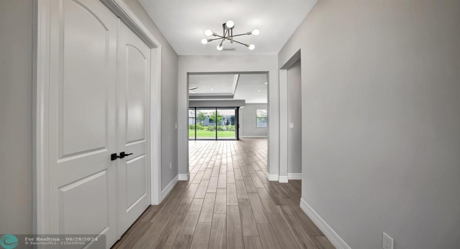 Foyer with Flex room to the left and Bedroom 2 to the right