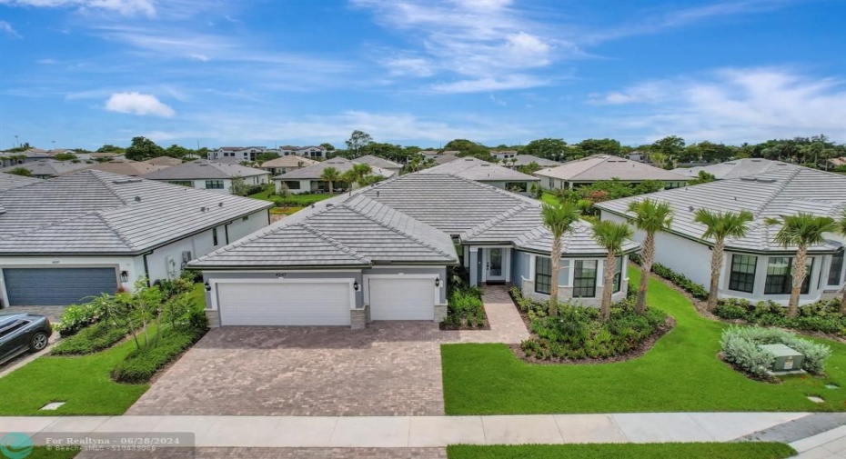 Front with 3 car drive way and oversized 3 car garage