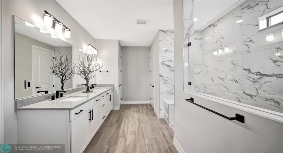 Primary bathroom with large walk-in shower, dual sinks, linen closet and dedicated water closet