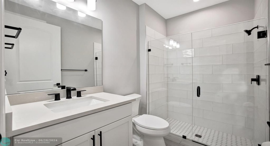 Bedroom 2 bathroom with linen and walk-in shower