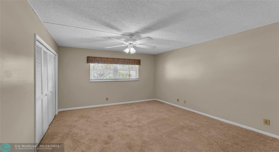 Master Bedroom is large and spacious with overhead ceiling fan with lighting, carpet flooring and wall of closets