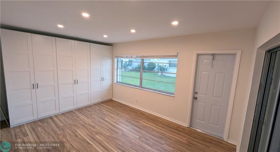 South West Bedroom with Ample Storage and Exits to back Porch and to Enclosed Outdoor Areas