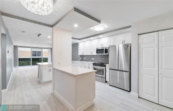 Open Lay-out updated kitchen with stainless steel appliances.