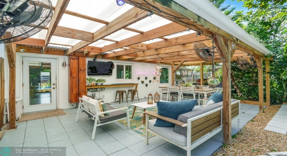 Back covered patio with tv and soundbar to watch from sofas or dining table