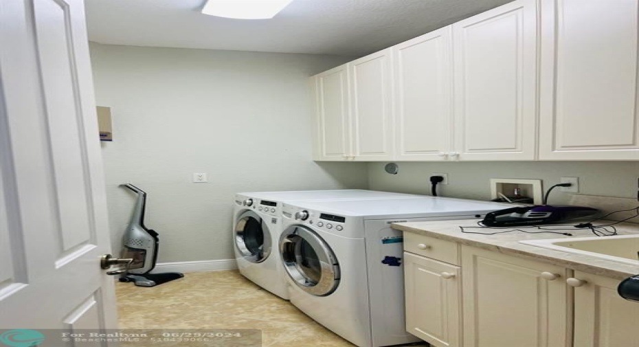 Laundry with sink, closets, and cabinets