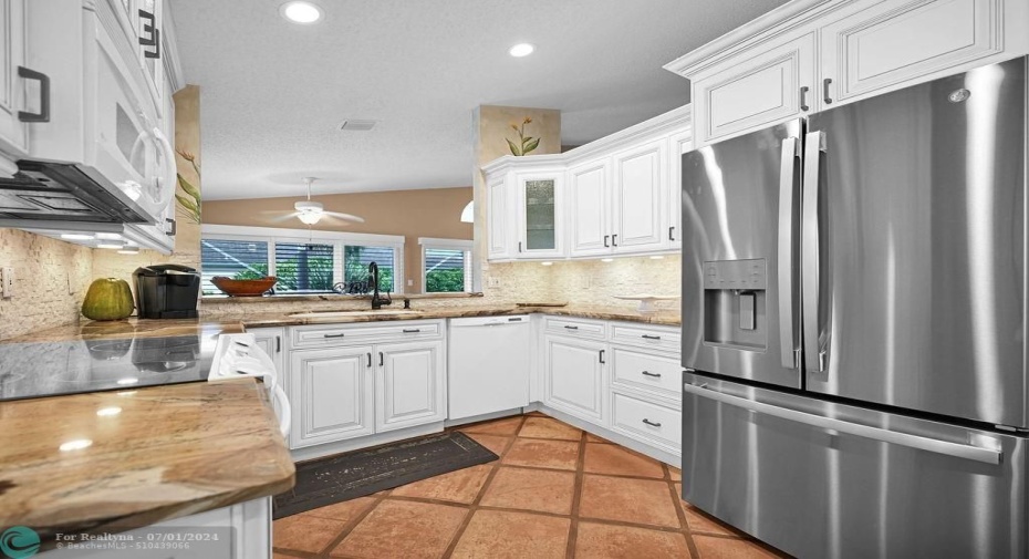 The upgraded kitchen has lots of storage space, stunning granite counters, designer features, under cabinet lighting, & more.