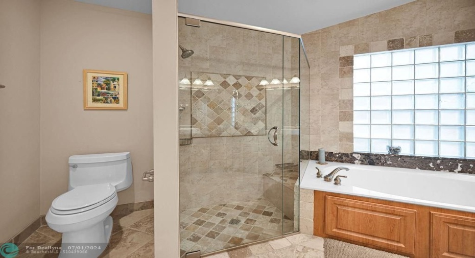 Designer tile, glass doors & a seat in the shower.