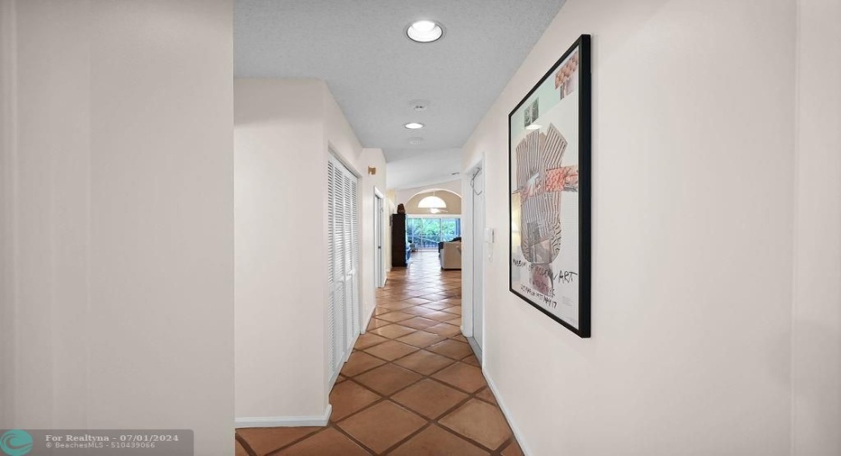 Open side hall leads to guest bedroom & bath.