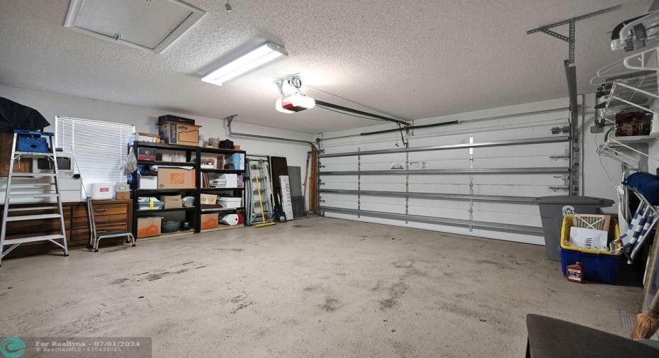 Large garage has a window for light, lots of room for storage.  Freestanding & built-in storage to stay.
