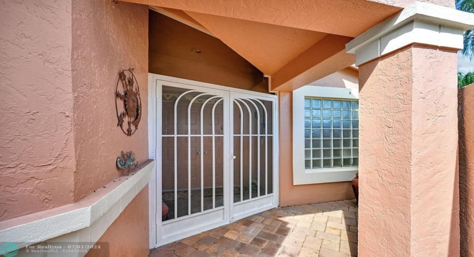 Your courtyard entrance leads to double screened doors to your main entrance.