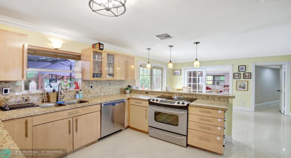 The Kitchen Features Granite Countertops, stainless steel appliances.