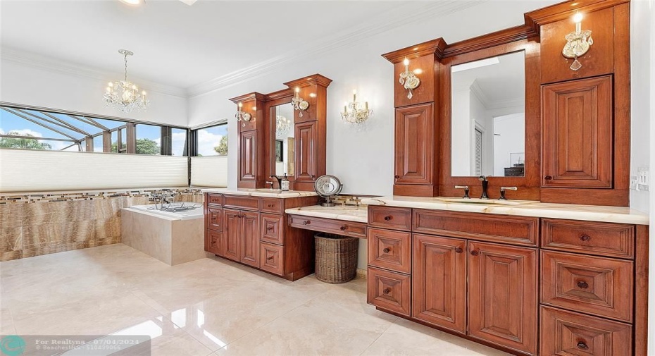Glamorous ensuite with soaking tub, open shower, backlit stone counters, and double vanities.