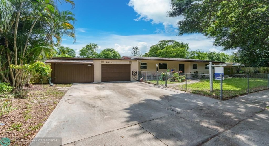 One car garage plus carport with fence in front yard