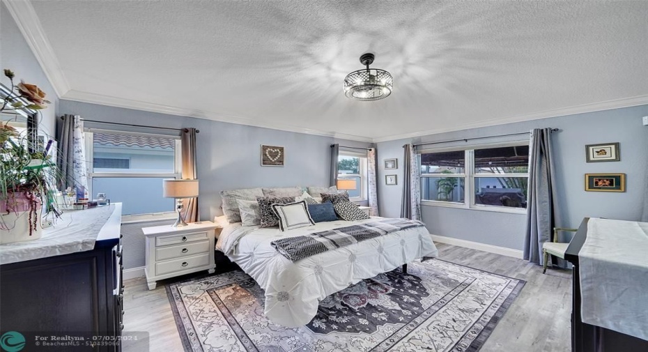 Spacious master suite has private access to the patio for quick morning dip in the pool