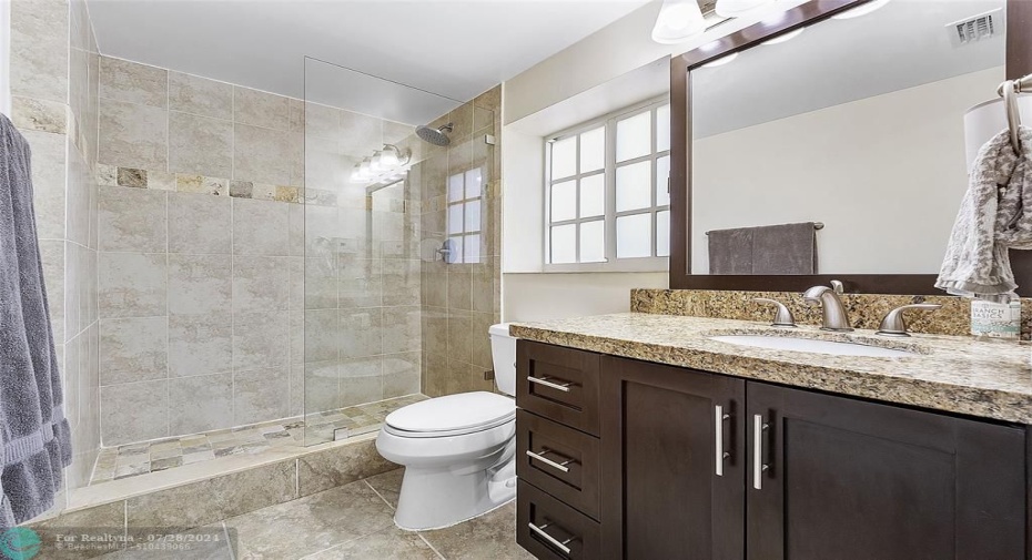 the modern master bathroom is spacious and pretty