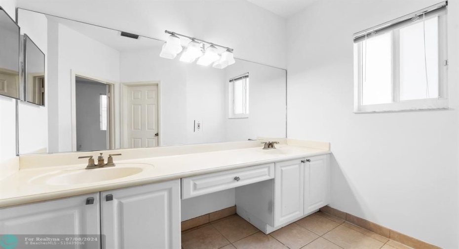 Primary en suite bath featuring dual sinks