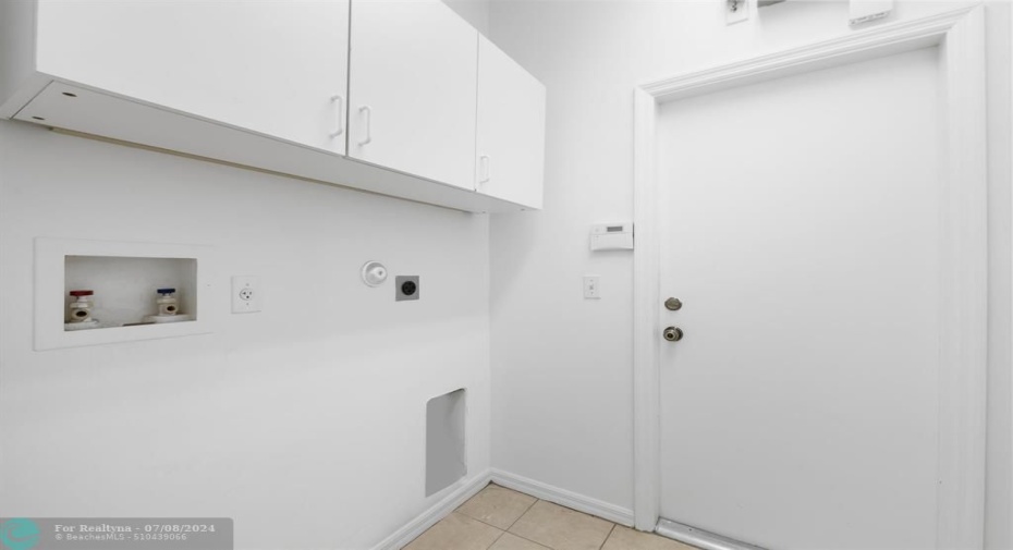 Utility room with washer / dryer hook up, extra storage and entry to 2 car garage
