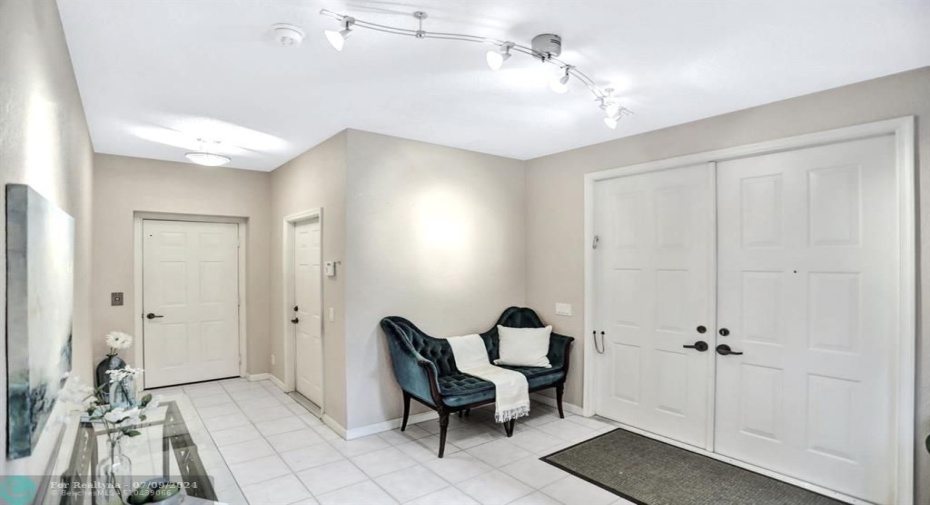 Double door entry opens to the spacious foyer, with private elevator to 2nd level.