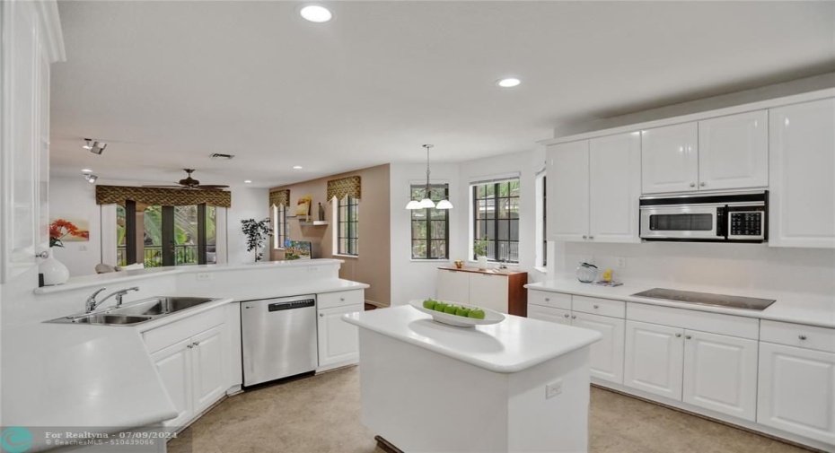 Sleek and chic, white on white kitchen, with pops of stainless steel - tons of storage!