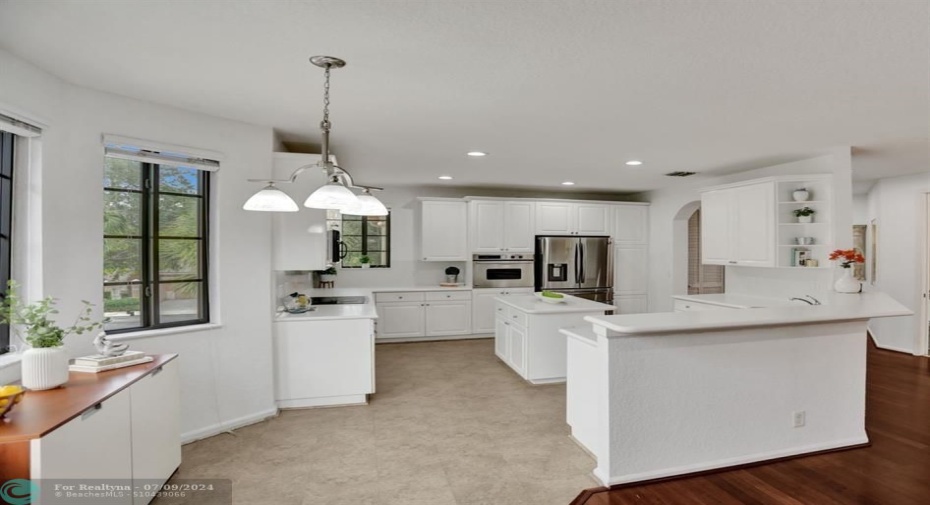 Very practical! Neutral tile flooring in the kitchen; breakfast area to the left!