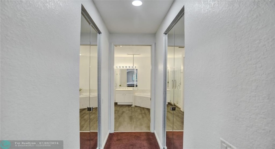 Passageway from bathroom to master suite, large double walk-in closets.