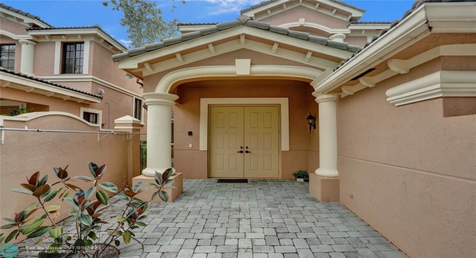 Brick paver courtyard with double door entry to your new home!