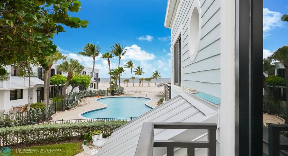 View of pool and ocean from unit balcony