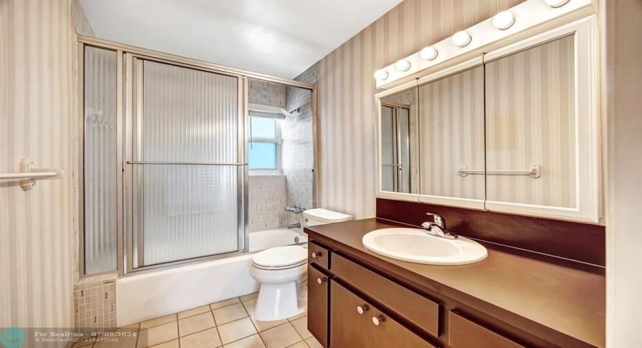 second bathroom has a window that provides a natural light.