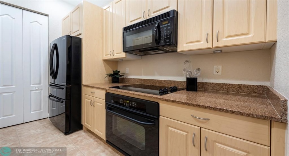 Your Gorgeous Kitchen has Beautiful Light Cabinetry, with Contemporary Modern Black Appliances