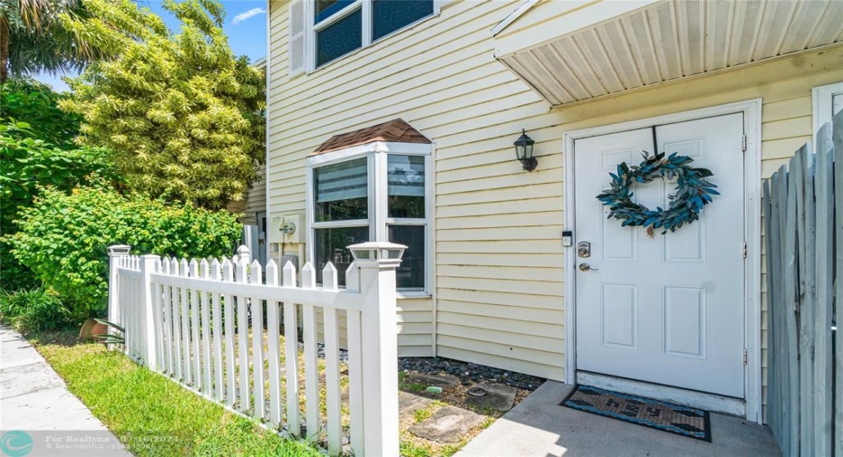Front Door with Lovely White Picket Fence & Landscaping