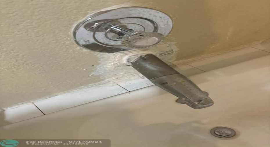 Per plumber, water damage in Primary bedroom tub