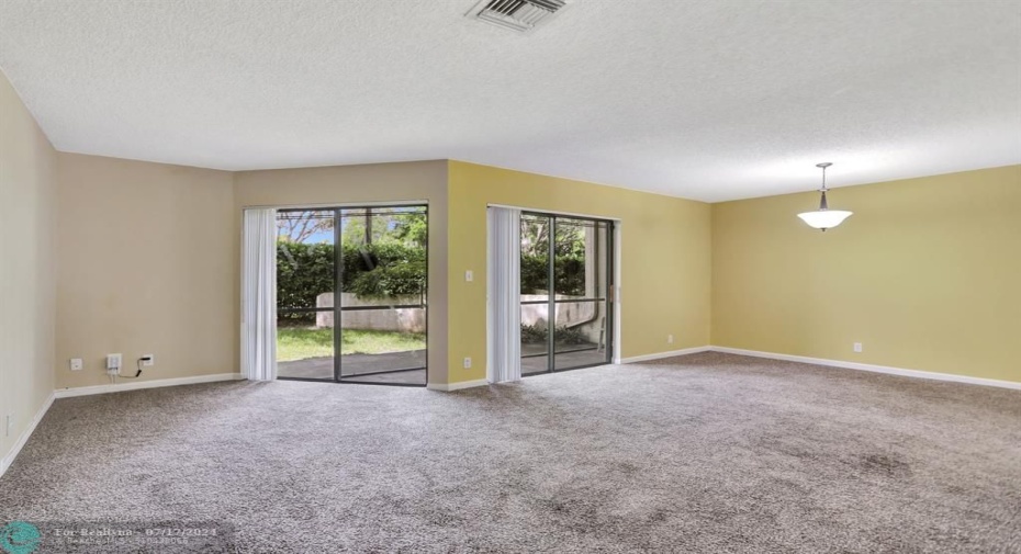 HUGE living room opens to screened, covered patio. Great for entertaining!