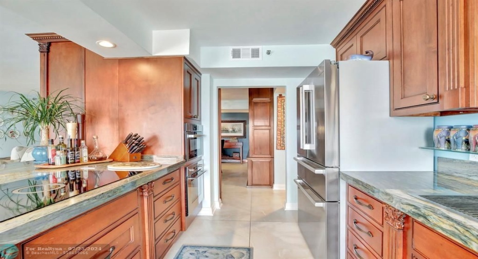 Remodeled kitchen with custom cabinetry, gorgeous high grade granite countertops, induction cooktop with cross-over bridges and quick heat setting, stainless fridge, Fisher & Paykel dish drawers, Bosch built-in wall microwave and oven.