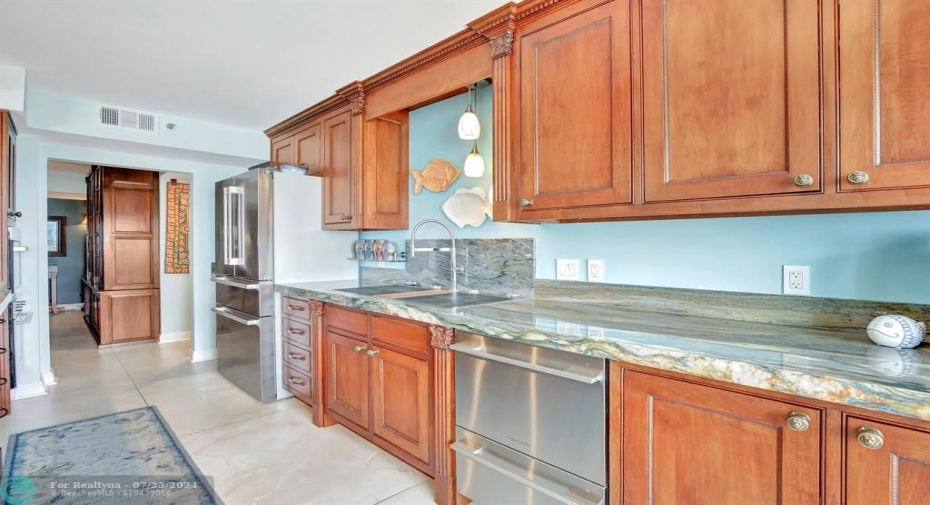 Remodeled kitchen with custom cabinetry, gorgeous high grade granite countertops, induction cooktop with cross-over bridges and quick heat setting, stainless fridge, Fisher & Paykel dish drawers, built-in Bosch wall microwave and oven.