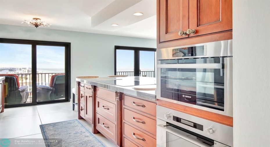 Remodeled kitchen with custom cabinetry, gorgeous high grade granite countertops, induction cooktop with cross-over bridges and quick heat setting, stainless fridge, Fisher & Paykel dish drawers, Bosch built-in wall microwave and oven.