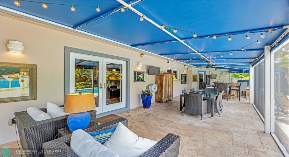 Outdoor Living, Dining, Bar, Kitchen and Grills in Screened in room overlooking the pool