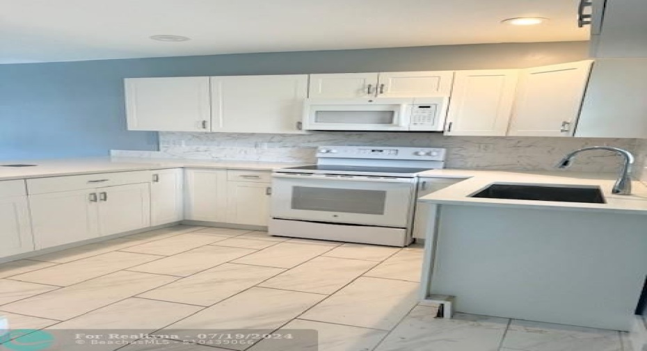 Upgraded white kitchen cabinets with Quartz counters