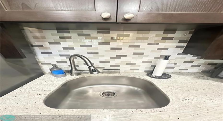 Stainless steel sink and tile backsplash